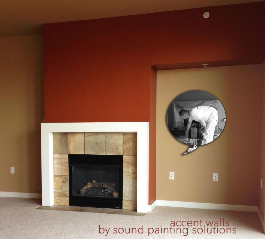 A photo of a red accent wall in Belltown. The portion painted red is a popout that also features a fireplace.