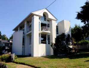 A Fauntleroy, West Seattle home painted by Sound Painting Solutions. The home is three stories, painted white, and features unique architecture. 