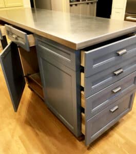 A kitchen island painted by Sound Painting Solutions, in a medium gray color