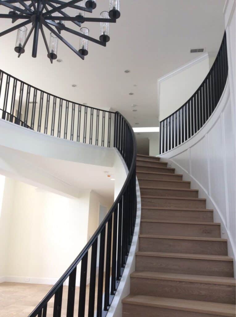 Interior painting of an ornate stairwell - white walls and trim