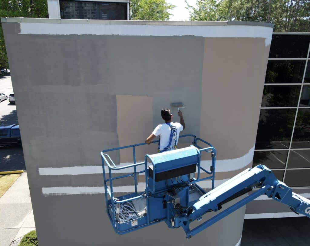 Image of the exterior of the building during painting. 