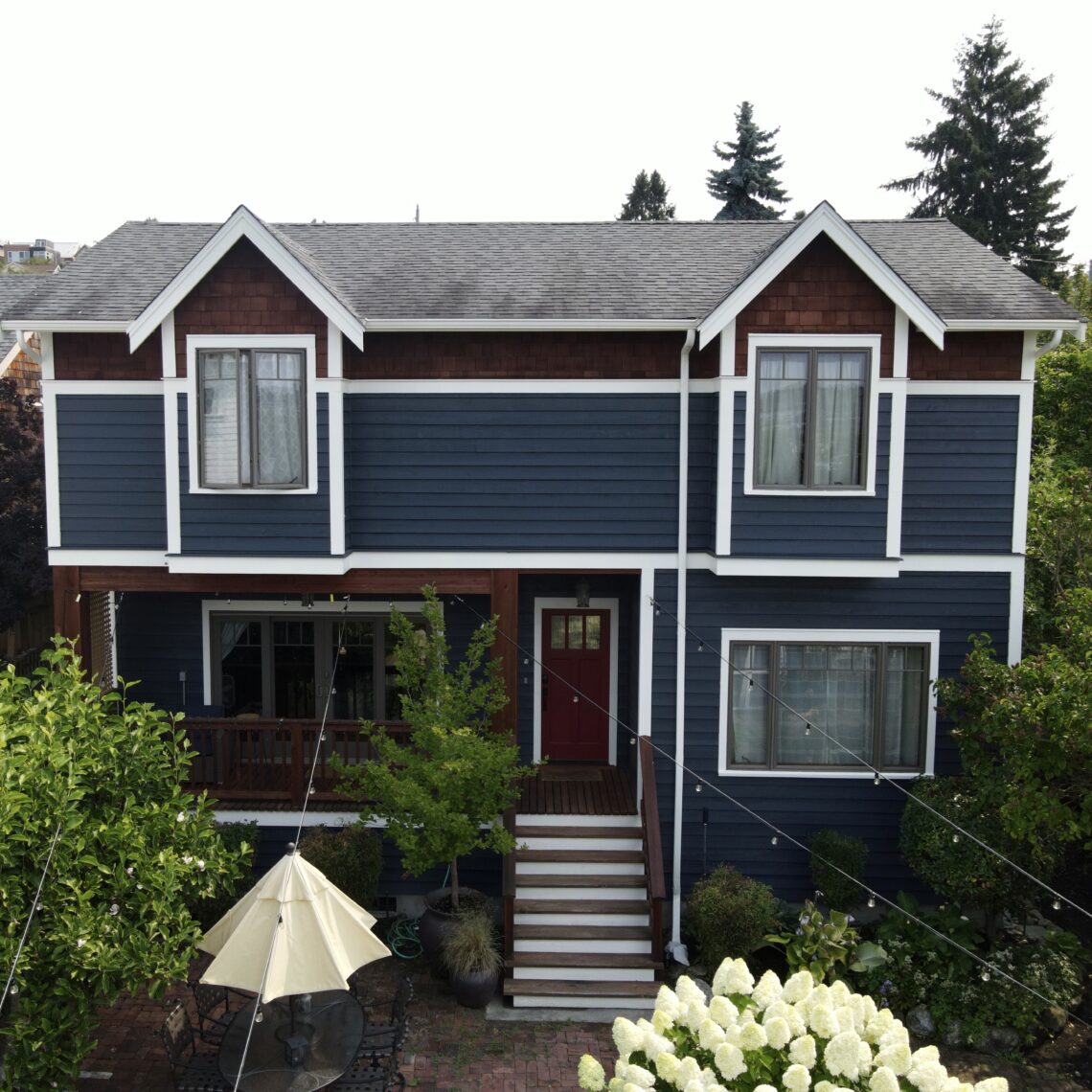 West Woodland exterior painting with navy/white color scheme and natural wood accents