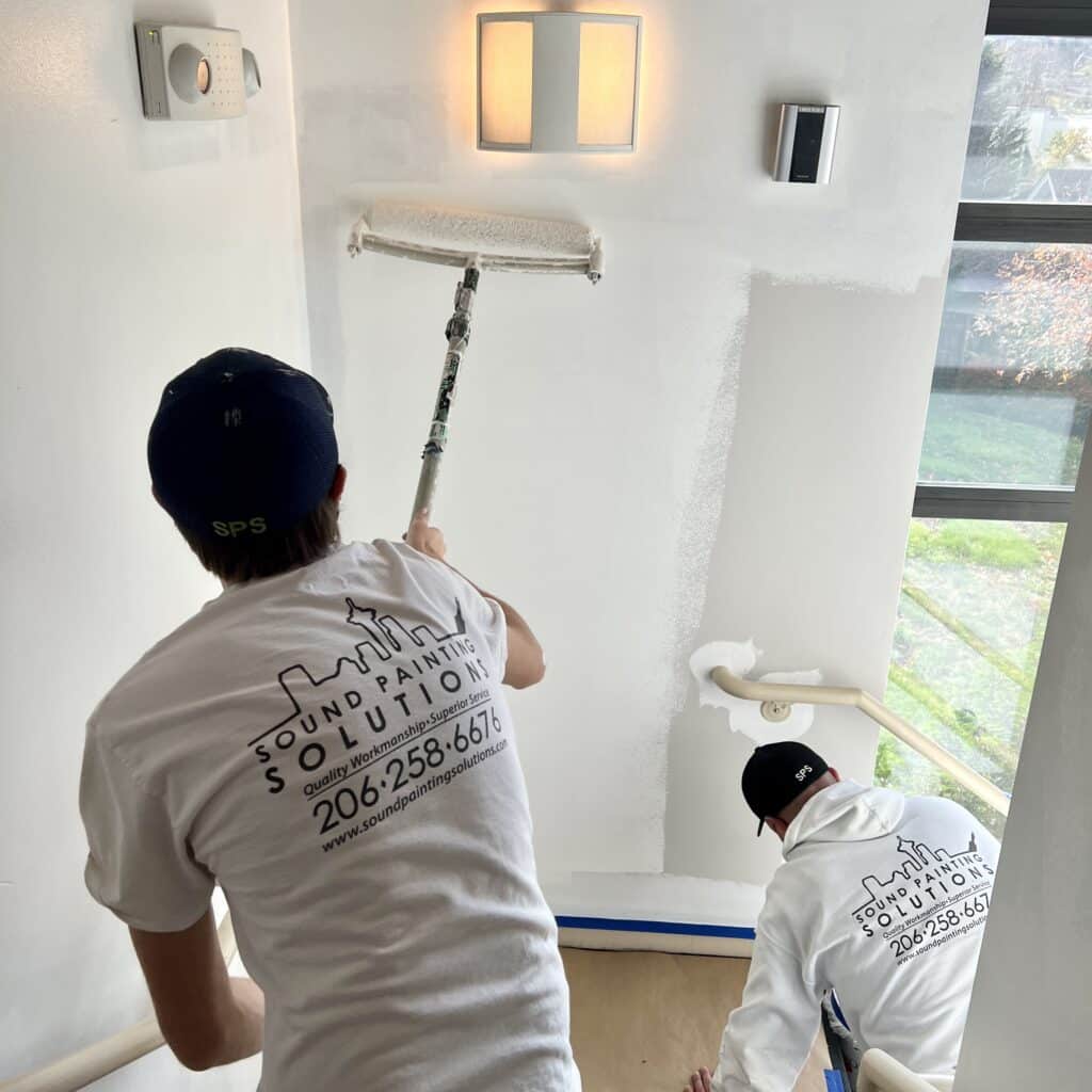 Painters in action during a volunteer painting event. 