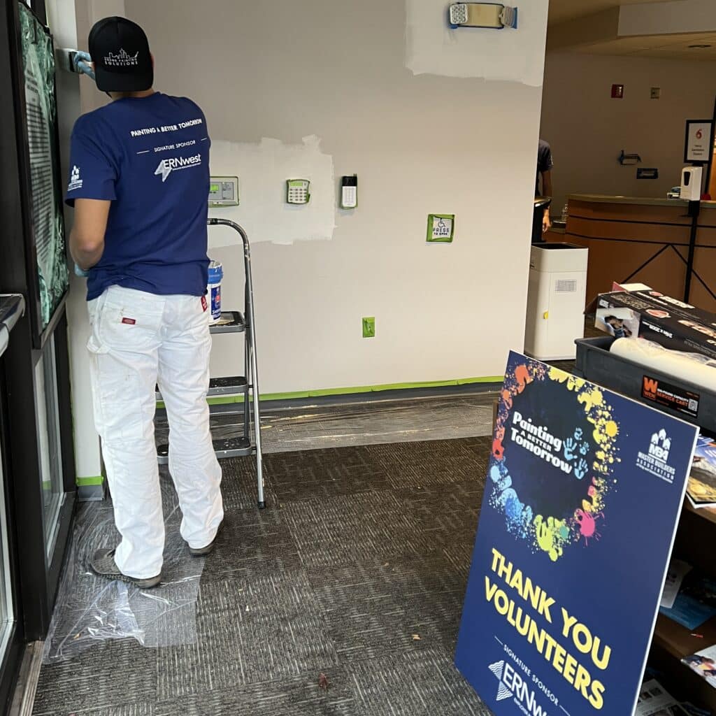 Painters in action during a volunteer painting event. 