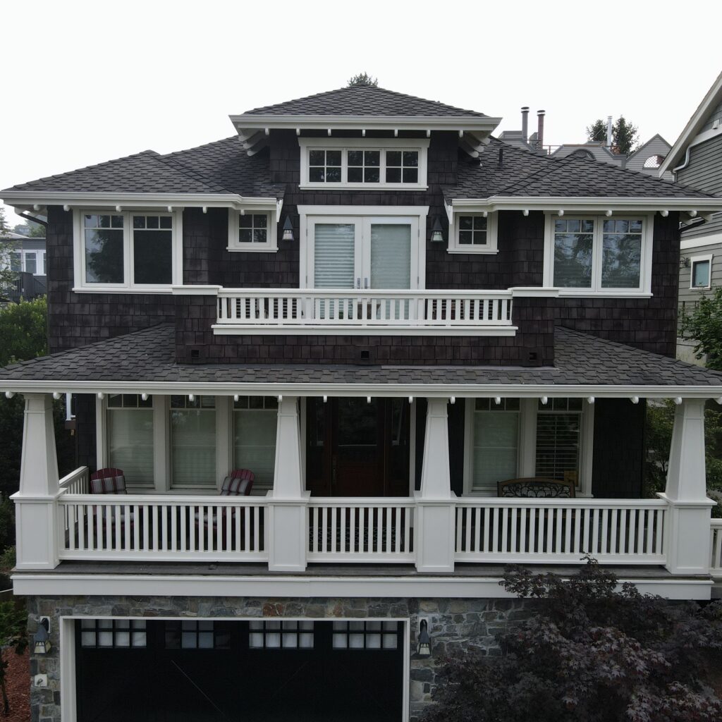 Exterior of the house after the body was stained and trim was painted. 