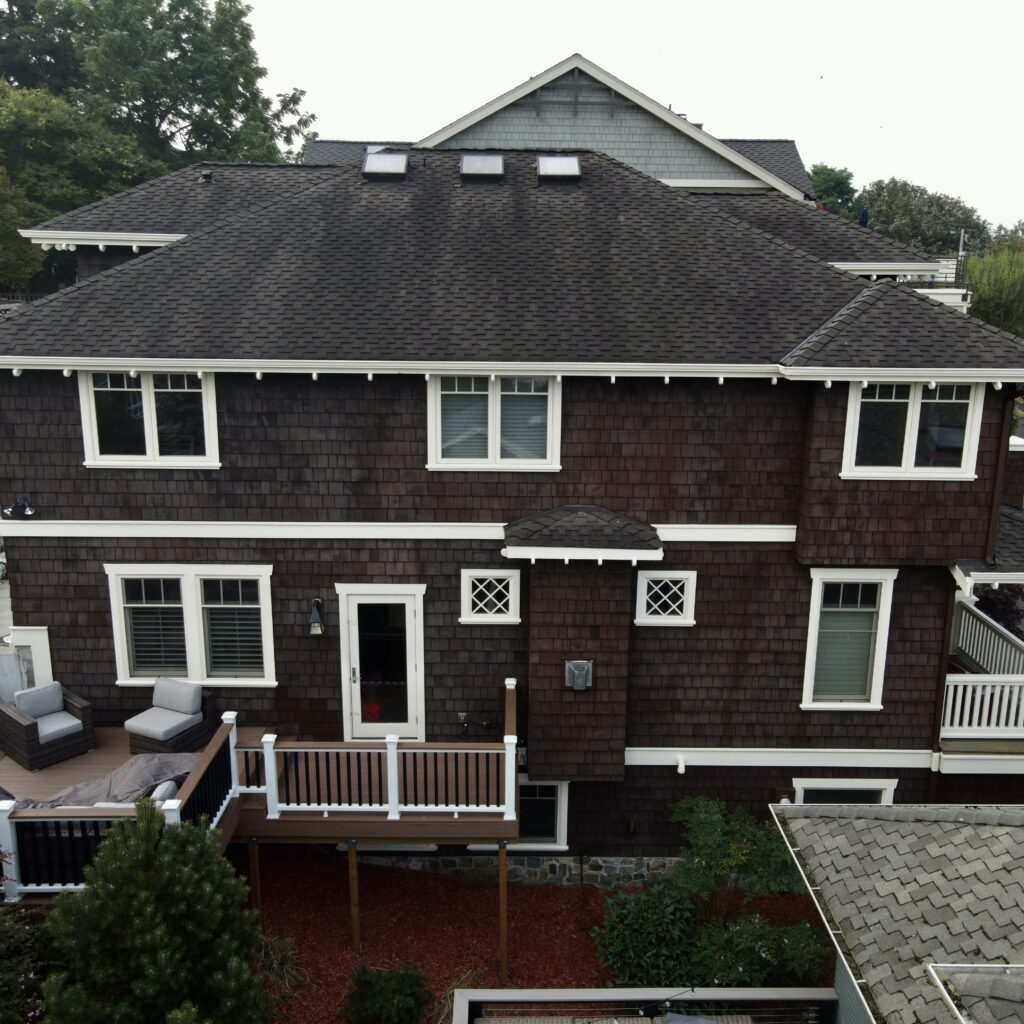 Exterior of the house after the body was stained and trim was painted. 