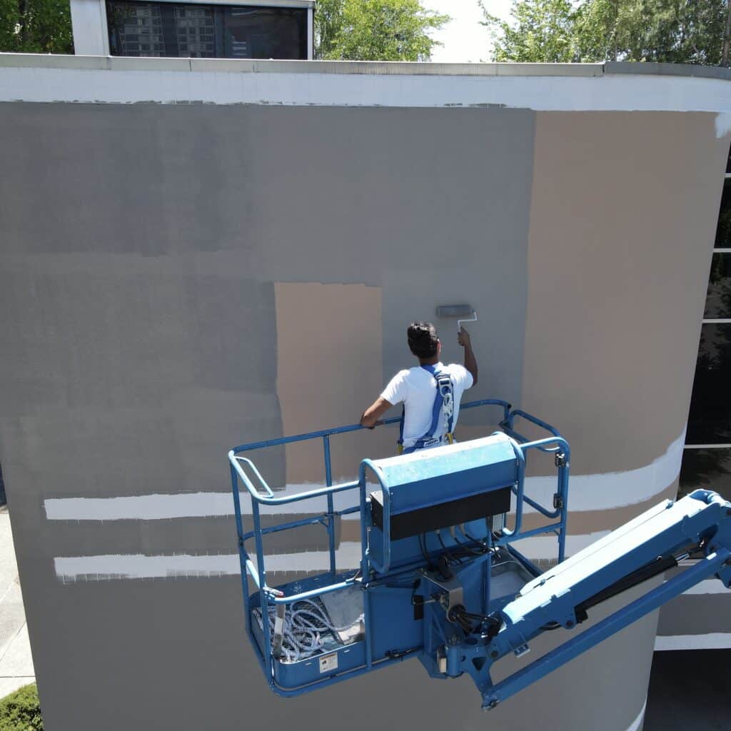Our painter working on an exterior commercial painting job in Seattle.
