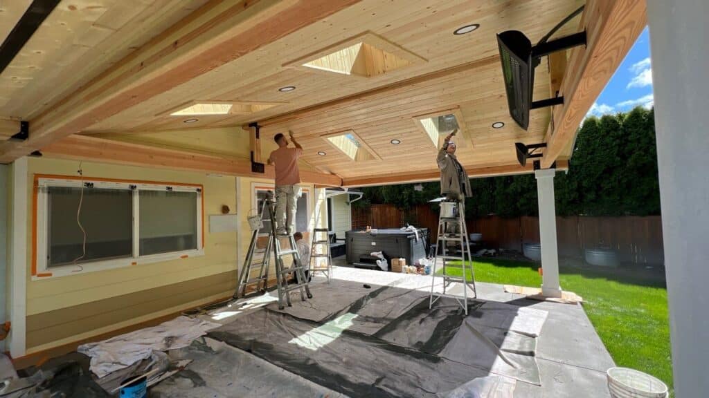 Painters staining an overhang